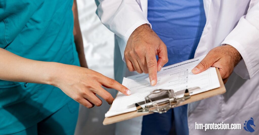 a nurse and doctor cehcking a sheet recording something
