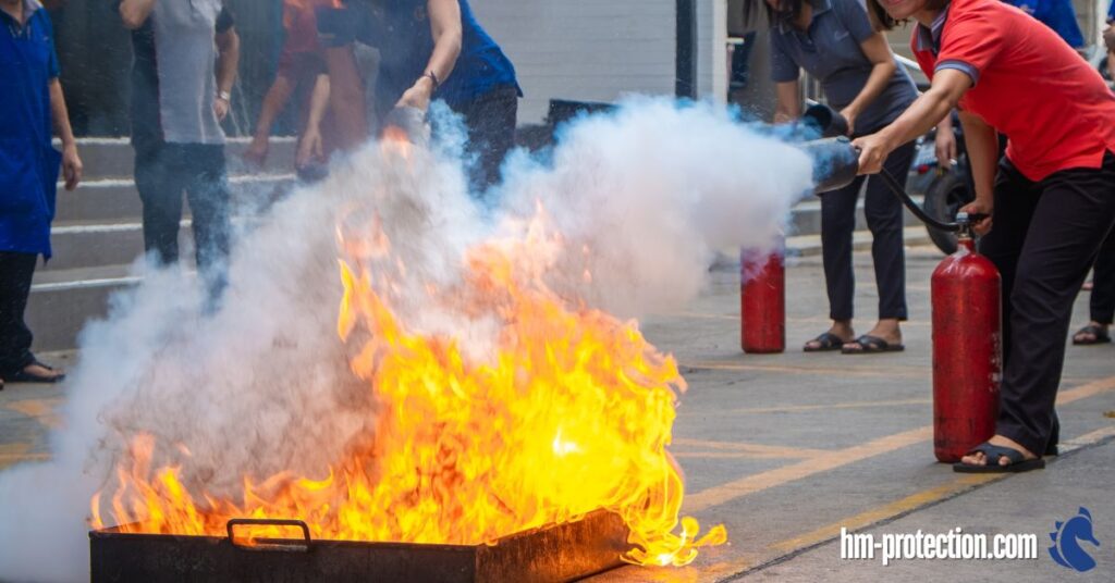 employee extinguishing a fire on a fire drill