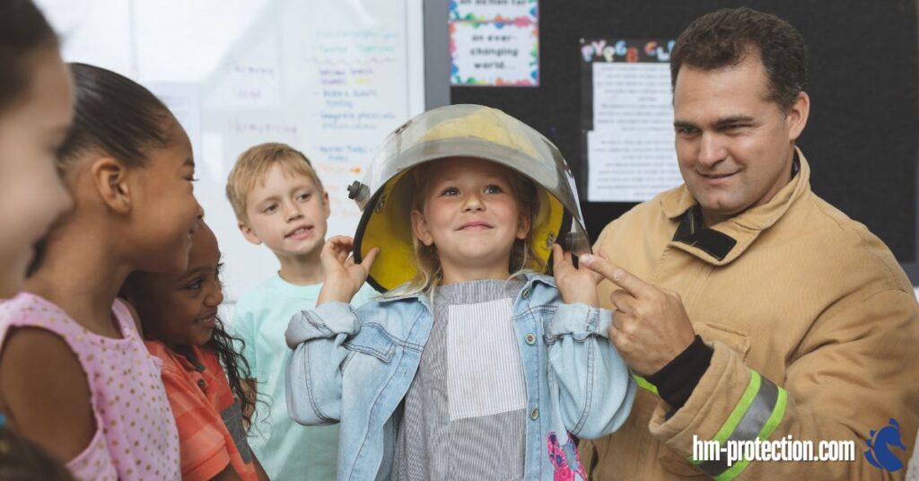 fireman putting a fireman's hat on a kid