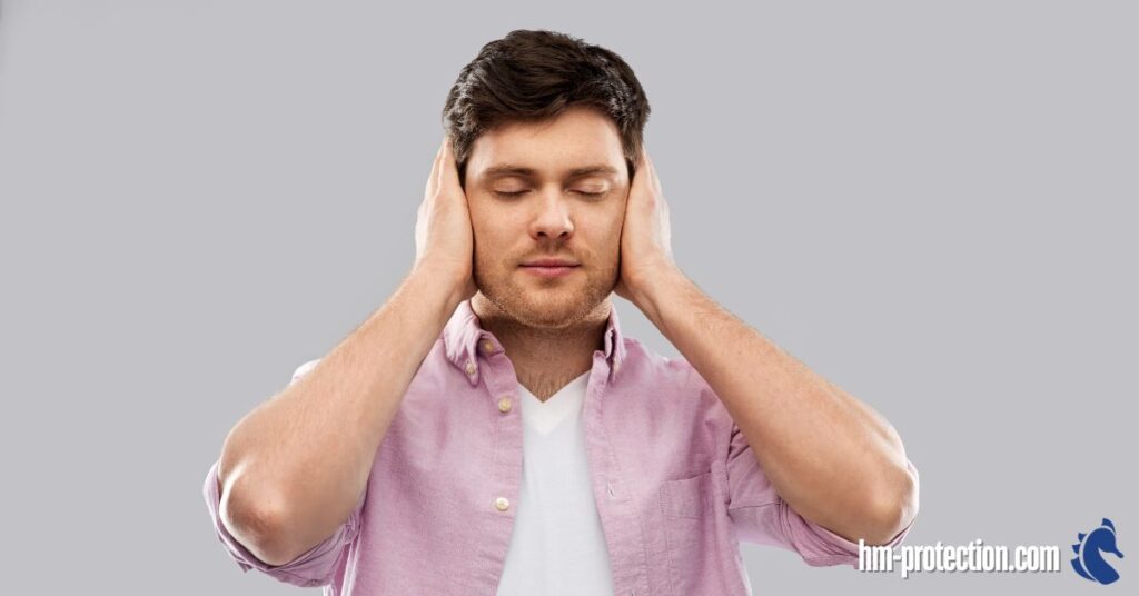 person in an open pink polo closing his eyes and ears