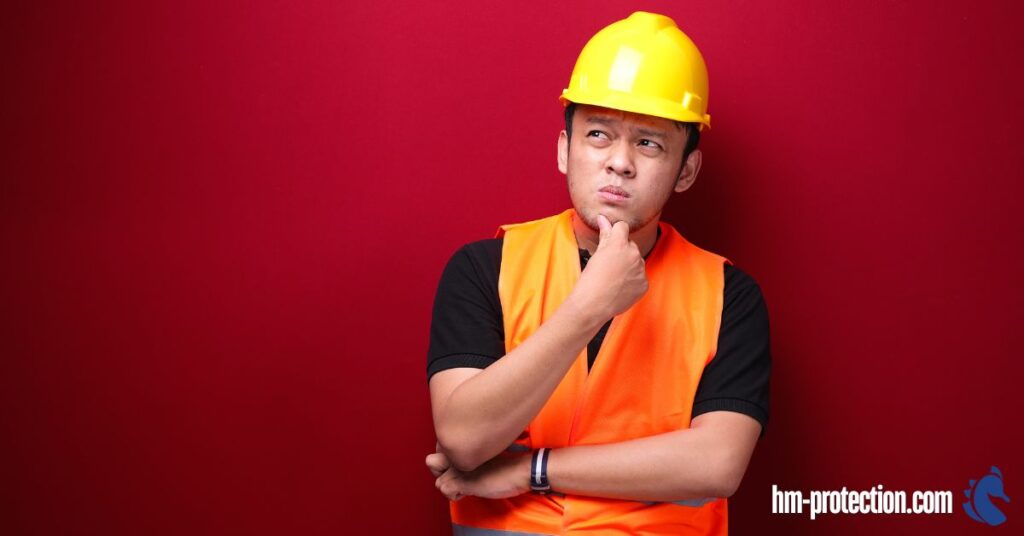 person in safety equipment thinking
