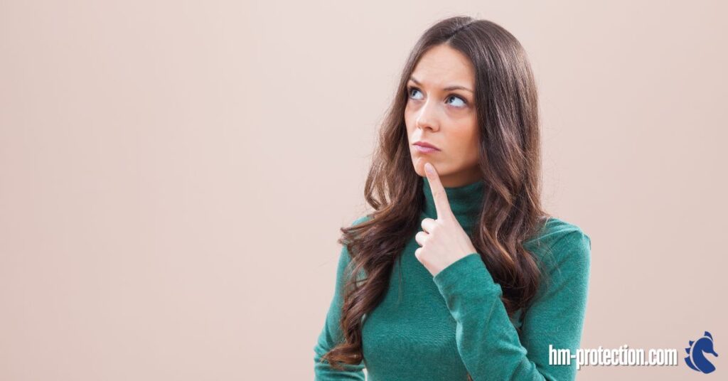woman in green dress thinking of something